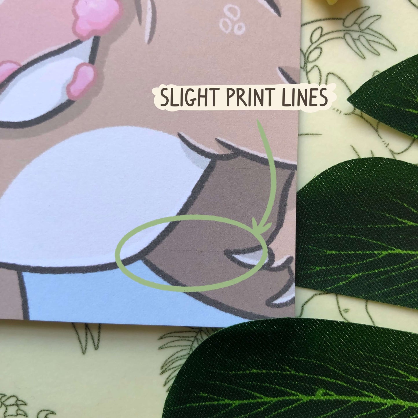 A close up of A6 art print of a Tyrannosaurus Rex looking at the viewer and holding a stick of cotton candy in its mouth. There are very faint print lines in a small section on the bottom right and this has been circled.